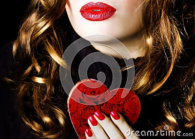 Young beautiful pretty woman holding a red heart makeup valentine love romance Stock Photo