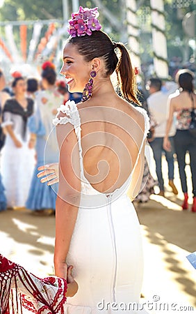 Young beautiful smiling woman dressed in traditional costumes at the Seville`s April Fair Editorial Stock Photo