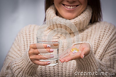 Happy woman taking vitamins and supplements. Vitamin K2, D, E, A Stock Photo