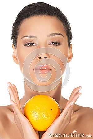 Young beautiful spa woman with orange in her hand Stock Photo