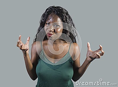 Young beautiful and stressed black African American woman feeling upset and angry gesturing agitated and looking crazy and Stock Photo