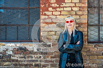 Young beautiful strong independent rebel blonde woman Punk music and style fan posing. Confident Punk-Rock youth culture street Stock Photo