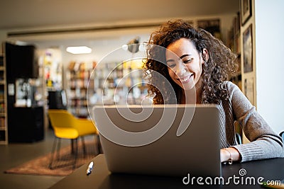 Young beautiful student girl working, learning in college library Stock Photo