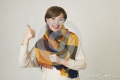 Young beautiful and stylish 30s red hair woman sweater and Autumn colorful scarf smiling happy Stock Photo