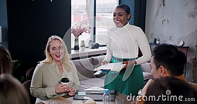 Young beautiful successful black female business coach leading team seminar at modern multiethnic office slow motion. Stock Photo