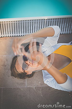 Young Beautiful Suntanned Woman wearing sunglasses relaxing Stock Photo