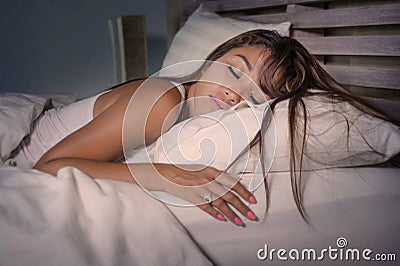 young beautiful and tired Asian woman 20s or 30s sleeping peacefully resting happy and relaxed dreaming on her bed at home apart Stock Photo