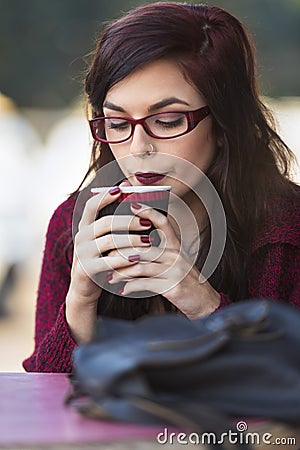 Young beautiful traveler enjoying a coffee at street cafe Stock Photo