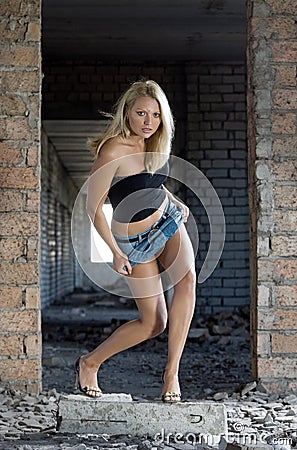 Young beautiful woman in abandoned construction Stock Photo