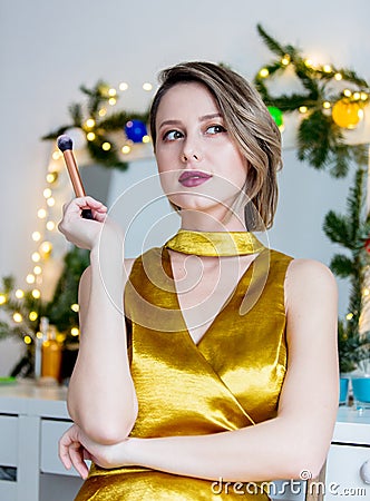 Woman applying cosmetics near decorated mirror Stock Photo