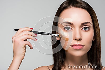 Woman with tonal foundation on face Stock Photo