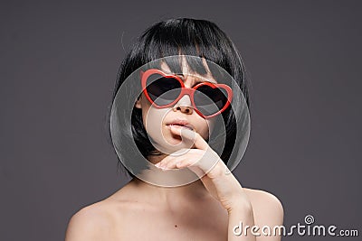 Young beautiful woman on a black background in sunglasses Stock Photo