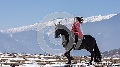 Young beautiful woman on black horse in riding in Transylvania mountains Editorial Stock Photo