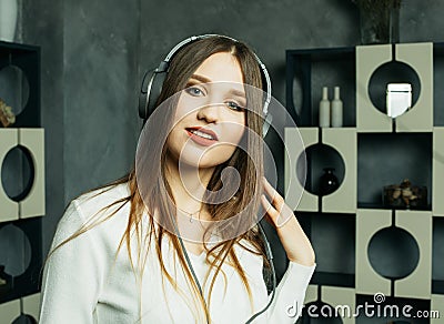 Young beautiful woman in casual outfit enjoying the music at home. Lifestyle, tehnology and people concept. Stock Photo