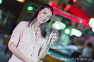Young beautiful woman chalking the snooker cue and smiling Stock Photo