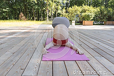 Young beautiful woman doing yoga poses in the park Stock Photo
