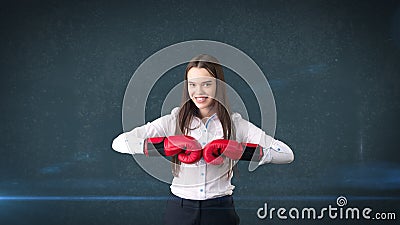 Young beautiful woman dress in white shirt standing in combat pose with red boxing gloves. Business concept. Stock Photo