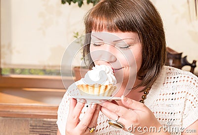 Young beautiful woman eating a dessert. Sweet life with cake Stock Photo