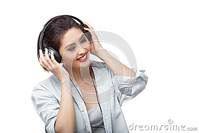 Young beautiful woman enjoy listening to music with big headphones isolated white background Stock Photo