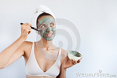 Young beautiful woman in face mask of therapeutic blue mud. Spa Stock Photo