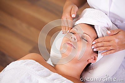 Young beautiful woman getting facial massage Stock Photo