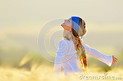 Young beautiful woman on golden cereal field Stock Photo