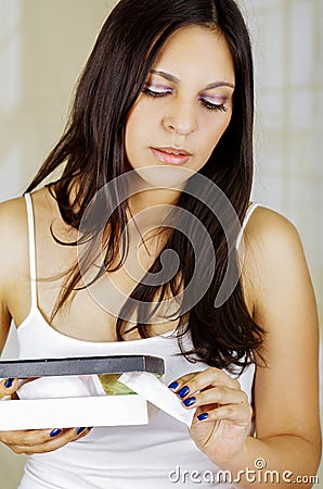 Young beautiful woman holding a cardboard box that includes a menstruation cotton tampon, sanitary towel used for Stock Photo