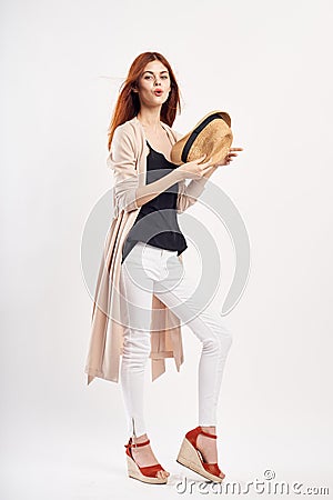 Young beautiful woman holding a hat on white isolated background, photo in full growth, fashion, beauty Stock Photo