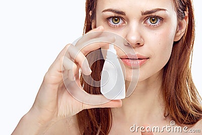 Young beautiful woman holds a drop on white isolated background, pharmacy, portrait Stock Photo