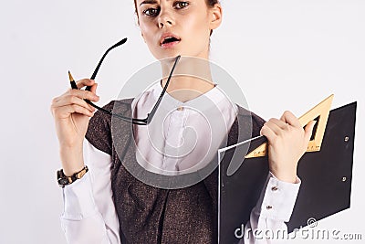 Young beautiful woman holds glasses on white isolated background, portrait, teacher Stock Photo