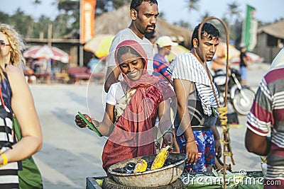 Young beautiful woman Indian woman making corn grilled on the be Editorial Stock Photo