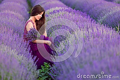 Young beautiful woman in lavender fields with a romantic mood Stock Photo