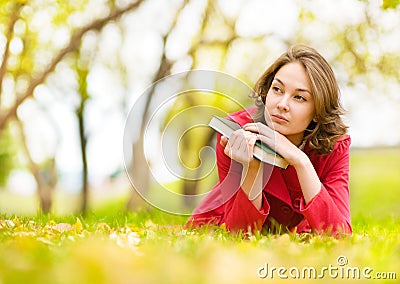 Young beautiful woman lays on a grass Stock Photo