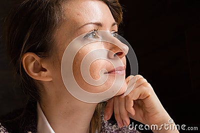 Young beautiful woman looking away and dreaming. Pretty girl with brown eyes thinking closeup. Daydreaming concept. Stock Photo