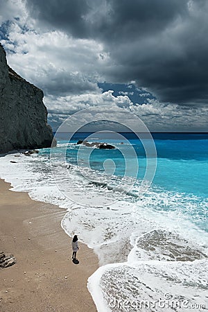 Young beautiful woman looks at the sea on the Porto Katsiki beach, Lefkada island, Greece Editorial Stock Photo