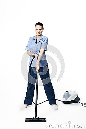 Young beautiful woman in a maid costume smiling and getting ready for vacuuming Stock Photo