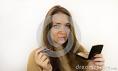 Young beautiful woman with makeup, painted with powder, lipstick, mascara Stock Photo