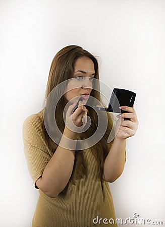 Young beautiful woman with makeup, painted with powder, lipstick, mascara Stock Photo