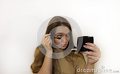 Young beautiful woman with makeup, painted with powder, lipstick, mascara Stock Photo