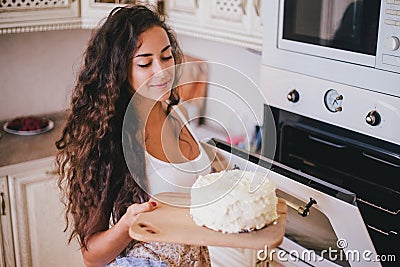 Young beautiful woman making cake at the kitchen Stock Photo