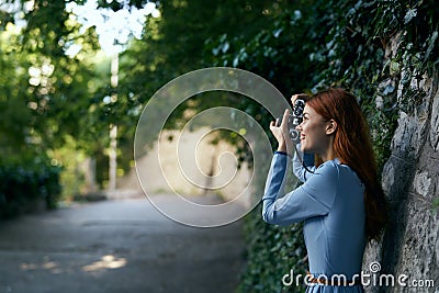 Young beautiful woman is making a photo at the camera in an alley in the city Stock Photo