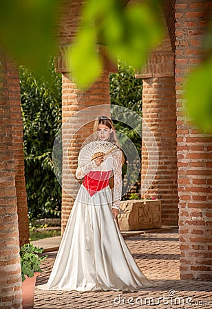 Young beautiful woman with medieval dress , romantic mood with white lace dress and fan Editorial Stock Photo