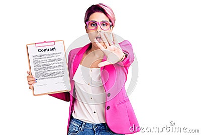 Young beautiful woman with pink hair holding clipboard with contract document doing stop gesture with hands palms, angry and Stock Photo