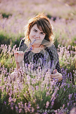 Young beautiful woman posing in a lavender field Stock Photo