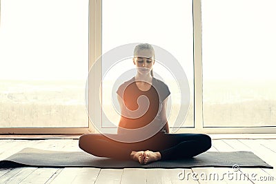 Young beautiful woman practicing yoga and gymnastic. Wellness concept. Classes in single sports. Stock Photo