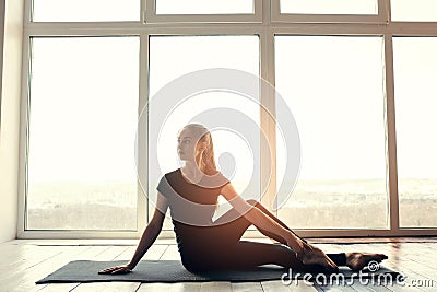Young beautiful woman practicing yoga and gymnastic. Wellness concept. Classes in single sports. Stock Photo