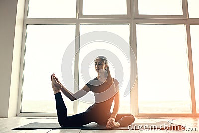 Young beautiful woman practicing yoga and gymnastic. Wellness concept. Classes in single sports. Stock Photo