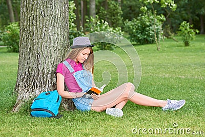 Young beautiful woman reading book at the park Stock Photo