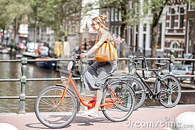 Woman with bicycle in Amsterdam city Stock Photo