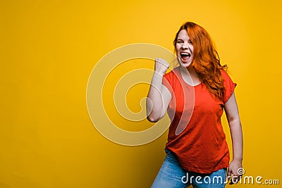 Young beautiful woman shows yes jesture, bright yellow background, copy space. Stock Photo